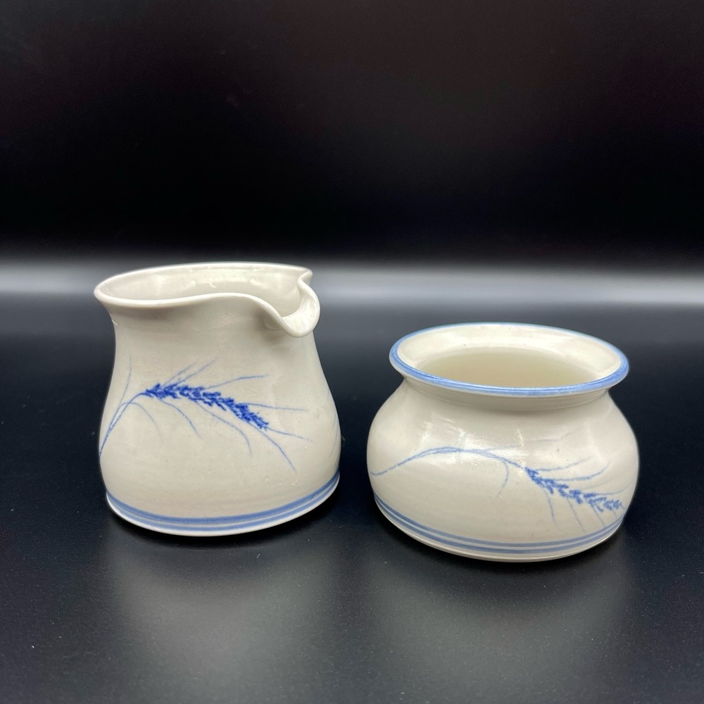 Artist signed cream & sugar set. Beautiful white w/blue wheat pattern pottery